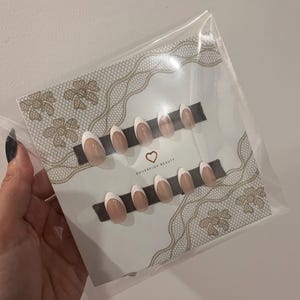 May include: A set of three ceramic mugs with a speckled, matte finish in cream, light grey, and dark grey. Each mug has a simple, minimalist design, ideal for coffee or tea.