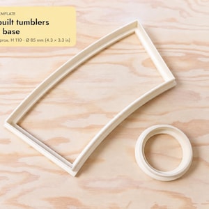 Könnte beinhalten: Ein weißes Kunststoff-Schablonenset für Töpferwaren, bestehend aus einer geschwungenen rechteckigen Wandform und einer runden Bodenform. Der Text lautet: TUMBLER TEMPLATE, Slab-built tumblers, wall + base, Finished approx. H 110, Ø 85 mm (4.3 x 3.3 in).