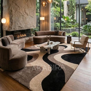 May include: A modern living room with a large stone fireplace, brown sofas, and a patterned rug. The rug features a wave design in black, beige, and brown. The word "AKABIRA" is printed on the rug.