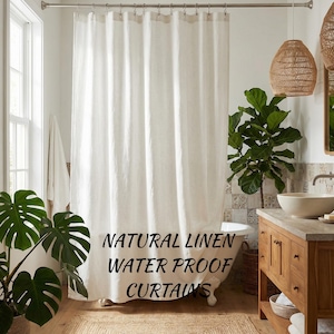 May include: A white natural linen waterproof shower curtain hangs in a bathroom. The text "NATURAL LINEN WATER PROOF CURTAINS" is printed on the curtain. The bathroom has a wooden vanity, a plant, and a window.