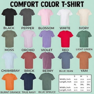 May include: A display of Comfort Color T-shirts in various colors, including black, white, and red. The image shows a size chart with measurements in inches for width and length, ranging from S to 3XL. The text "COMFORT COLOR T-SHIRT" is at the top.