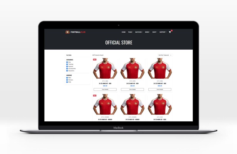 May include: A laptop screen showing a football club's official online store. The website features red and white football shirts. The words "OFFICIAL STORE" are displayed at the top. The laptop is on a white surface.