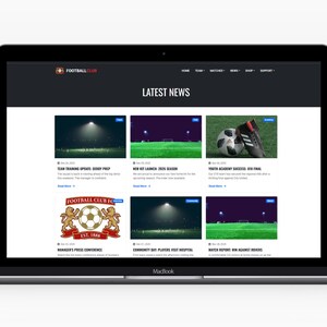 May include: A MacBook laptop showing a football club website. The website has a dark theme and displays "LATEST NEWS". The articles include images of a football, boots, and a football pitch. The website's logo is visible.
