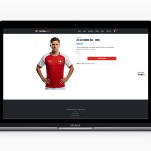 May include: A laptop screen shows a red and white football shirt. The shirt has white sleeves and a red body with a team emblem. The text "24/25 HOME KIT - MEN" is displayed above the shirt image.