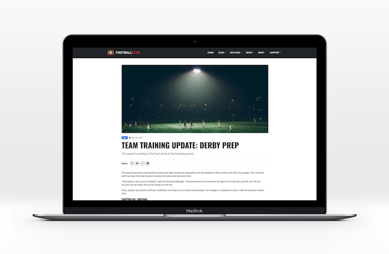 May include: A MacBook laptop shows a Football Live webpage with the headline "TEAM TRAINING UPDATE: DERBY PREP". The image on the webpage shows a football team training on a green pitch under bright stadium lights. The laptop is on a white surface.