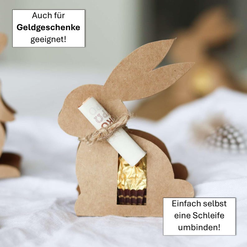 May include: A brown cardboard bunny-shaped gift box with a cutout for treats. A rolled-up paper is tied to the bunny's neck with twine. The box contains a gold-wrapped chocolate. Text on the image says, "Also suitable for money gifts!" and "Simply tie a bow yourself!"