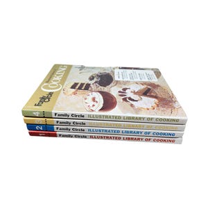 May include: A set of four cookbooks with a yellow, blue, and red spine. The books are titled "Family Circle Illustrated Library of Cooking".