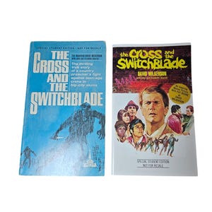May include: Two vintage paperback books, "The Cross and the Switchblade." The book on the left has a blue cover with a silhouetted figure. The book on the right has a white cover with a photo of a man and several people. Both are student editions.
