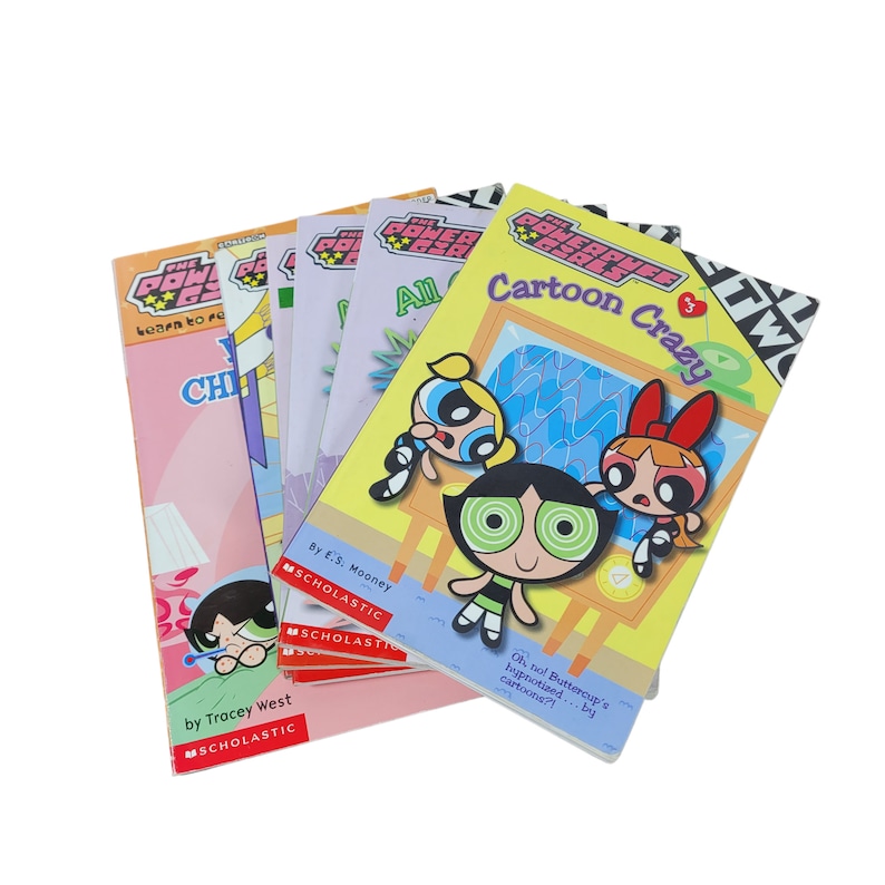 May include: A stack of five paperback books featuring the Powerpuff Girls. The books are titled "Learn to Read with the Powerpuff Girls", "Cartoon Crazy", "All Grown Up", "Chilling with the Powerpuff Girls", and "The Powerpuff Girls:  The Movie".