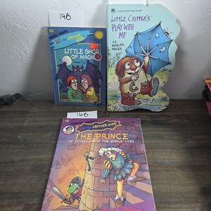 May include: Three children's books by Mercer Mayer. Titles include "Little Shop of Magic", "Little Critter's Play With Me", and "The Prince: An Adventure in the Middle Ages". The books feature colorful illustrations and are set on a wooden surface.