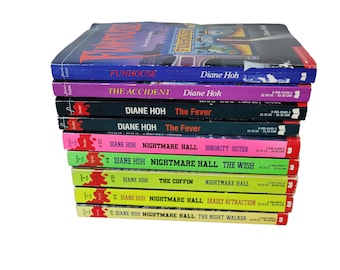 May include: A stack of paperback books with colorful covers. Titles include "Funhouse," "The Accident," and "Nightmare Hall." The books are by Diane Hoh and feature a "Thriller" label. The spines display the book titles and author names.