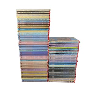May include: A stack of 50 paperback books with colorful covers. The books are all part of the "Baby-Sitters Club" series by Ann M. Martin. The books are arranged in order from the first book to the last book in the series.