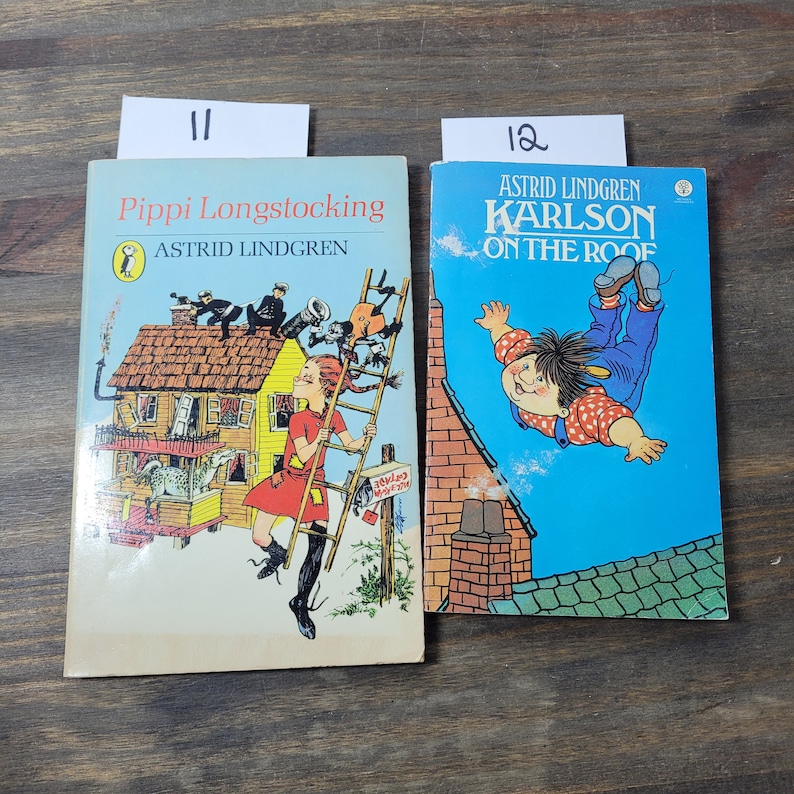 Puede incluir: Dos libros infantiles vintage, "Pippi Calzaslargas" de Astrid Lindgren y "Karlsson en el tejado" de Astrid Lindgren. Las portadas presentan ilustraciones coloridas de los personajes.