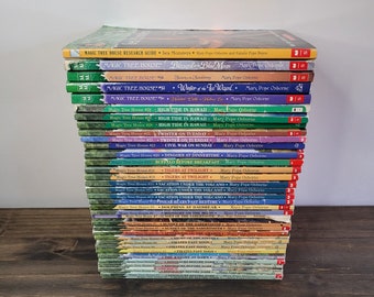 May include: A stack of Magic Tree House books by Mary Pope Osborne. The books are arranged in order from the most recent to the oldest. The titles include "Sea Monsters", "Blizzard and the Blue Moon", "Winter of the White Wizard", "High Tide in Hawaii", "Twister on Tuesday", "Civil War on Sunday", "Buffalo Before Breakfast", "Tigers at Twilight", "Vacation Under the Volcano", "Polar Bears Past Bedtime", "Dolphins at Daybreak", "Midnight on the Moon", "Sunset on the Sabertooth", "Knight on the Amazon", "Pirates Past Noon", "Dinosaurs Before Dark", and "Dinosaurs Before Dark".