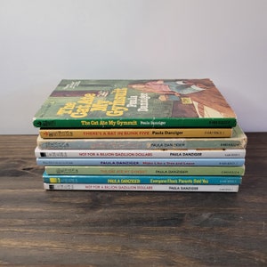May include: A stack of eight paperback books by Paula Danziger. The books are all different colors and have titles like "The Cat Ate My Gymsuit", "There's a Bat in Bunk Five", and "Not for a Billion Gazillion Dollars".