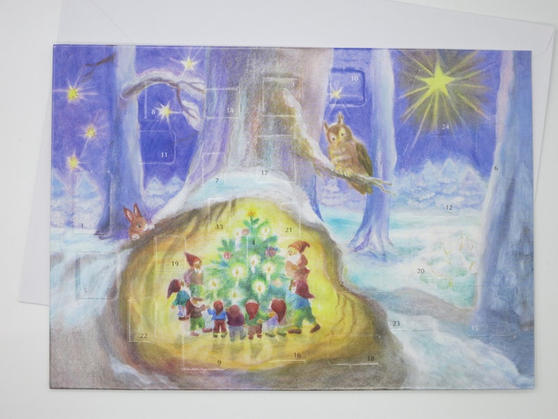 May include: A vintage Christmas advent calendar illustration featuring a snowy forest scene with a group of gnomes gathered around a lit Christmas tree. The illustration is painted in watercolor and features a blue and purple sky with stars and a bright yellow star at the top. The numbers 1 through 24 are visible on the calendar.