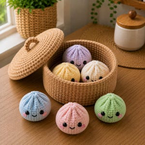 May include: A round, tan crocheted basket with a matching lid containing three small, plush, crocheted dumpling-shaped toys in lavender, yellow, and cream. Three additional plush dumpling toys in blue, pink, and light green sit in front.