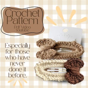 May include: Two crochet hair clips in shades of brown and cream, displayed on a white card. The clips have a bow-like design. Text on the image reads "Crochet Pattern" and "Especially for those who have never done it before."