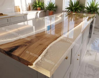May include: A custom kitchen island with a live edge wood countertop. The countertop is made of light-colored wood and clear resin with embedded sparkles. The island has white cabinets with gold hardware. The text "ar wooden creation" is visible.