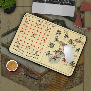 May include: A rectangular mousepad featuring a vintage Japanese illustration with red dots and figures. The design includes text and images of warriors on horseback. A white computer mouse rests on the pad.