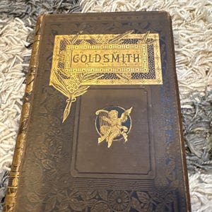 Antique Victorian Goldsmith Book (1880s) – Ornate Gilt Cover with Cherub – Decorative Cloth Binding – Dark Academia Library Decor