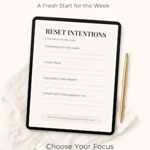 May include: A digital planner with the text "RESET INTENTIONS" and "A Fresh Start for the Week." The planner includes sections for intentions, focus, boundaries, and habits. A gold pen rests beside the planner.