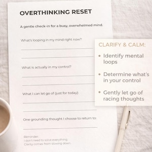 May include: A white one-page checklist titled "Overthinking Reset" with prompts to identify mental loops and manage thoughts. A pen and a cup of coffee are next to the checklist.