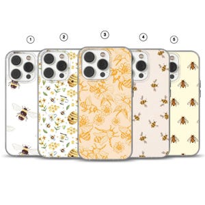 May include: Five phone cases with bee-themed designs. The cases feature various patterns, including bees, flowers, and honeycomb. The colour palette includes white, yellow, and beige. The cases are made of clear plastic and have a glossy finish.