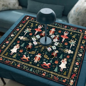 May include: A dark green square tablecloth featuring a repeating pattern of nutcrackers, ballerinas, rocking horses, and Christmas trees. A dark gray mushroom-shaped lamp sits in the center, surrounded by several small white mahjong tiles.