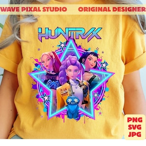 May include: Yellow t-shirt featuring a graphic design with the word "HUNTRAX" in purple and blue. The design includes three female characters inside a star, with a blue creature at the bottom. The shirt also has the text "WAVE PIXAL STUDIO ORIGINAL DESIGNER".