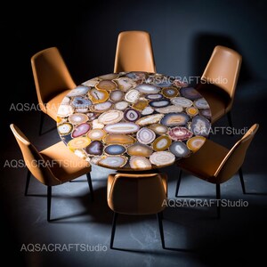 May include: A circular dining table with a mosaic top made of polished agate stones in various colours. Six tan leather chairs with black metal legs surround the table, creating a modern dining set.