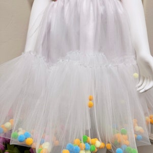 Twirl in Style: Let your child dance through the day in our chic skirt adorned with fluffy white pompoms!