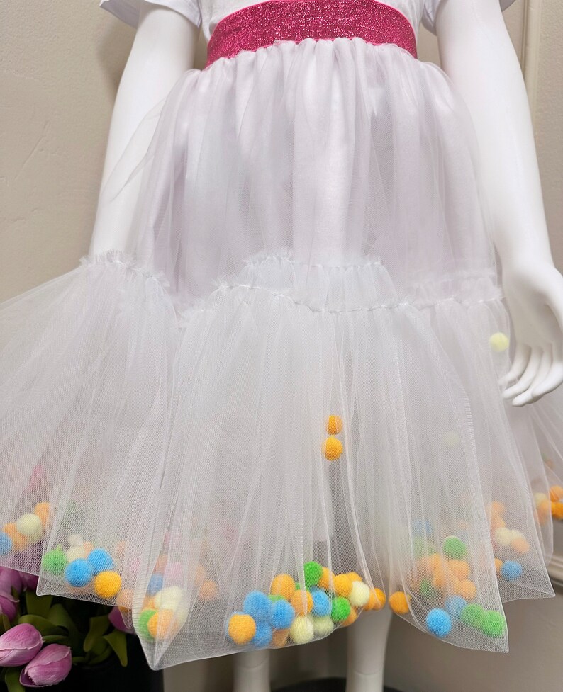 Twirl in Style: Let your child dance through the day in our chic skirt adorned with fluffy white pompoms!