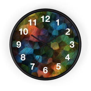 May include: A round wall clock with a black frame. The clock face features a colorful abstract design with shades of orange, blue, green, and yellow. White numerals mark the hours, and black hands indicate the time.