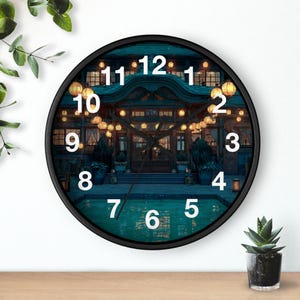 May include: Round black wall clock featuring a detailed illustration of a Japanese-style building at night, illuminated by warm-toned lanterns. The clock face displays white numerals and hands, with a dark teal background.