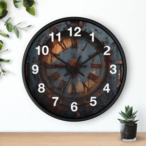 May include: Round wall clock with a black frame. The clock face has a distressed, rusty blue and brown design with white numerals and Roman numerals. The clock hands are black.
