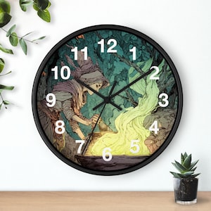 May include: Round black wall clock depicting a witch stirring a cauldron with a green and yellow flame. The clock has a black frame, white numbers, and black hands. The witch is wearing a hat and cloak.