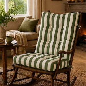 May include: A wooden rocking chair with a green and white striped cushion. The chair has a dark brown frame and armrests. The cushion is button-tufted. The chair is placed on a woven rug in a cozy living room setting.