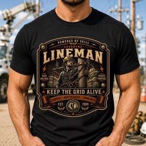May include: A black t-shirt featuring a graphic design of a lineman working on a utility pole. The text reads "POWERED BY SKILL", "LINEMAN", "KEEP THE GRID ALIVE", "HIGH VOLTAGE", "HIGHER PURPOSE", "COURAGE BROTHERHOOD COMMITMENT", "EST. 1988", and "LUVARYNX".
