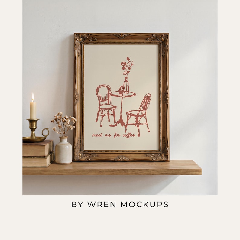 A4 ornate wood frame mockup styled on a warm wooden shelf with vintage books, a lit taper candle in a brass holder, and dried florals in a small ceramic vase, evoking old-world cottagecore charm. Overlay text reads "By Wren Mockups."