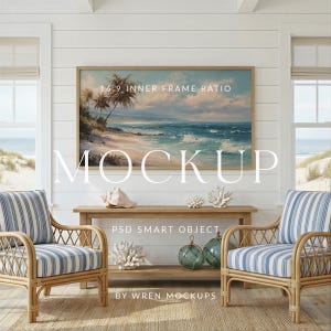 May include: A coastal-themed interior mockup featuring a large framed landscape painting above a wooden console table. Two rattan armchairs with blue and white striped cushions flank the table. Decorative coral and glass spheres add to the beachy aesthetic. The word "MOCKUP" is displayed.