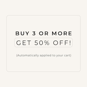 May include: A rectangular graphic with a light beige background featuring black text that reads BUY 3 OR MORE, followed by GET 50% OFF! inside a rounded black-outlined box, and the text (Automatically applied to your cart) at the bottom.