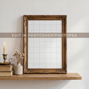 Antique carved wood frame mockup shown with a transparent grid overlay inside the frame opening, styled atop a wooden shelf with candle and book decor for a cozy, neutral-toned scene. Overlay text reads "Edit in Photoshop/Photopea."