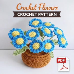 May include: A crochet pattern for a bouquet of blue and yellow flowers in a brown crocheted pot. The flowers have blue petals and yellow centers. The text "Crochet Flowers CROCHET PATTERN" is at the top of the image.