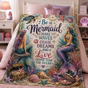 May include: A rectangular throw blanket featuring two mermaids, a treasure chest with pearls, seashells, and starfish. The text reads: Be a Mermaid MAKE WAVES CHASE DREAMS AND Live DEEPER THAN THE OCEAN. The design includes coral and bubbles.