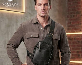 May include: Black leather sling bag with a front zippered pocket and adjustable strap. The bag is worn across the body. The logo "CRAFTLINE - LEATHER-" is visible in the upper left corner.