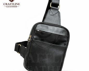 May include: Black leather sling bag with a zippered main compartment and an exterior pocket. The bag features a shoulder strap and a waist strap with gold-colored metal hardware. The logo "CRAFTLINE LEATHER" is visible in the upper left corner.