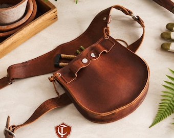 May include: A brown leather tool belt with an adjustable strap, silver-toned metal buckles, and multiple pockets for storage. The leather has a smooth, polished finish with visible stitching. The logo for Craftline Leather is printed at the bottom.