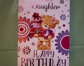 May include: A birthday card for a daughter with a teddy bear holding gifts and a cupcake. The card has the words "For A Special Daughter" and "Happy Birthday" in pink and purple lettering, with floral and star accents.