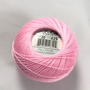 May include: A pink ball of Elizabeth 6-cord cordonnet embroidery thread. The label reads "Size 20 Col. 629" and "25g = 210 yds".